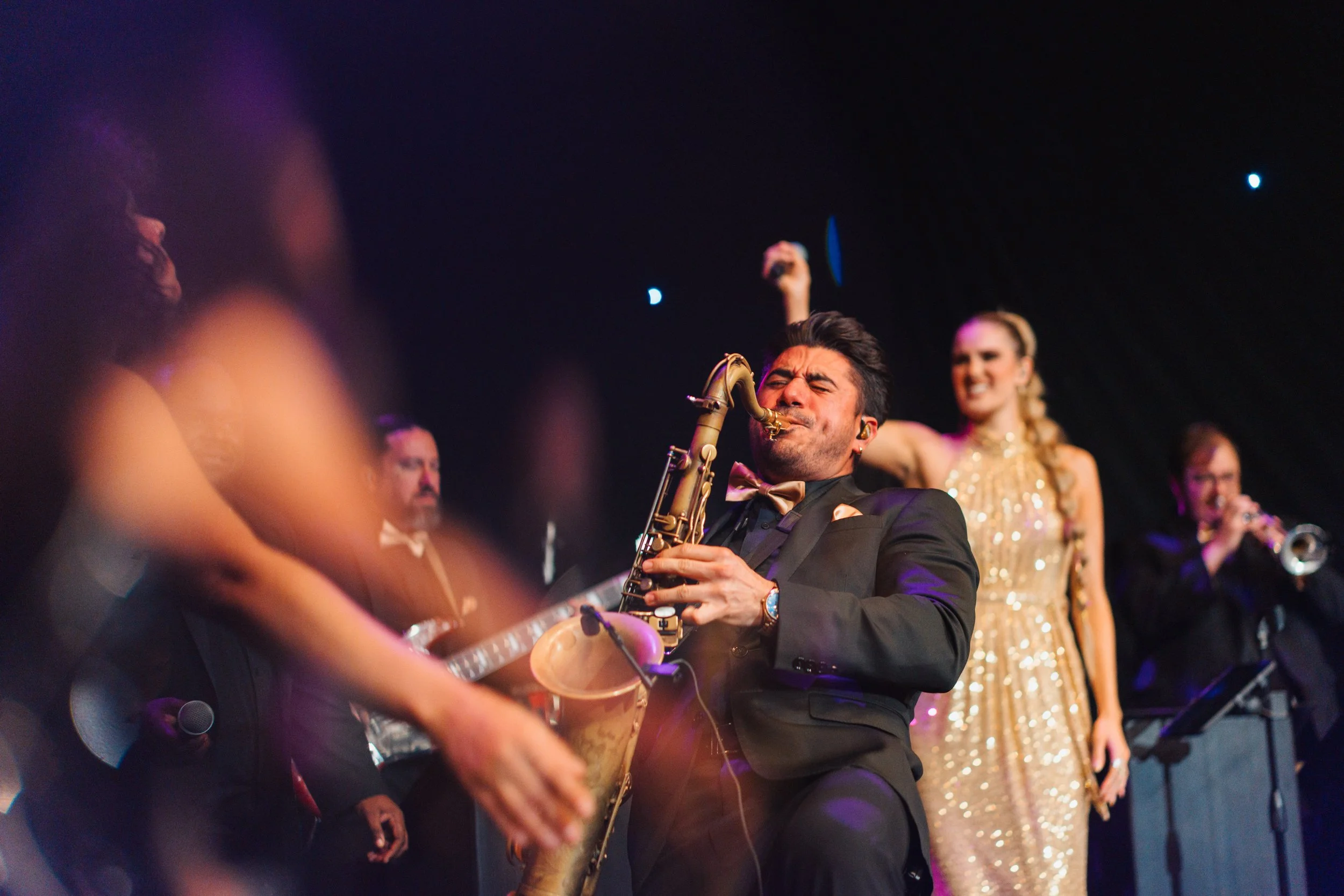 Downbeat vocalists performing on stage.