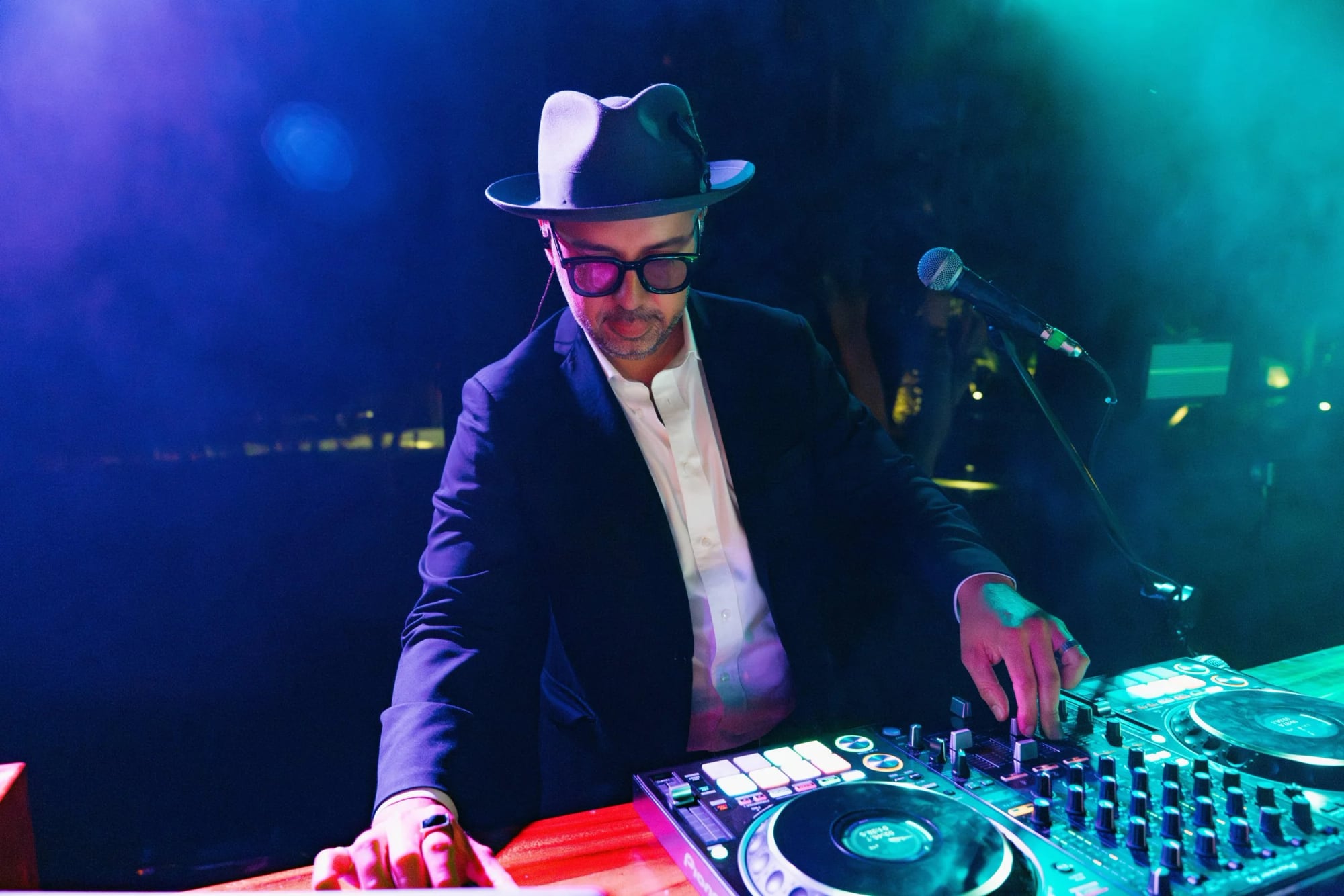 DJ Live musicians with DJ, saxophone, and percussion.