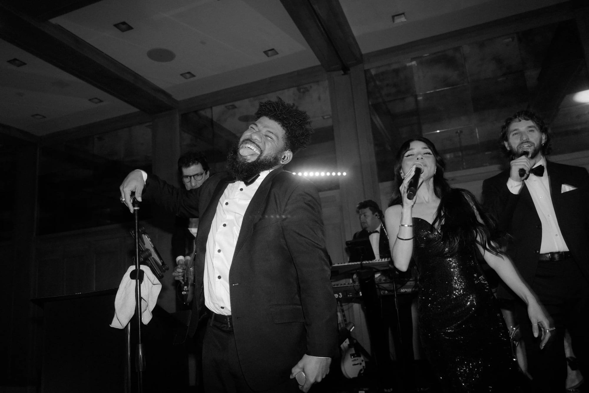 AMFM vocalists performing live on stage.