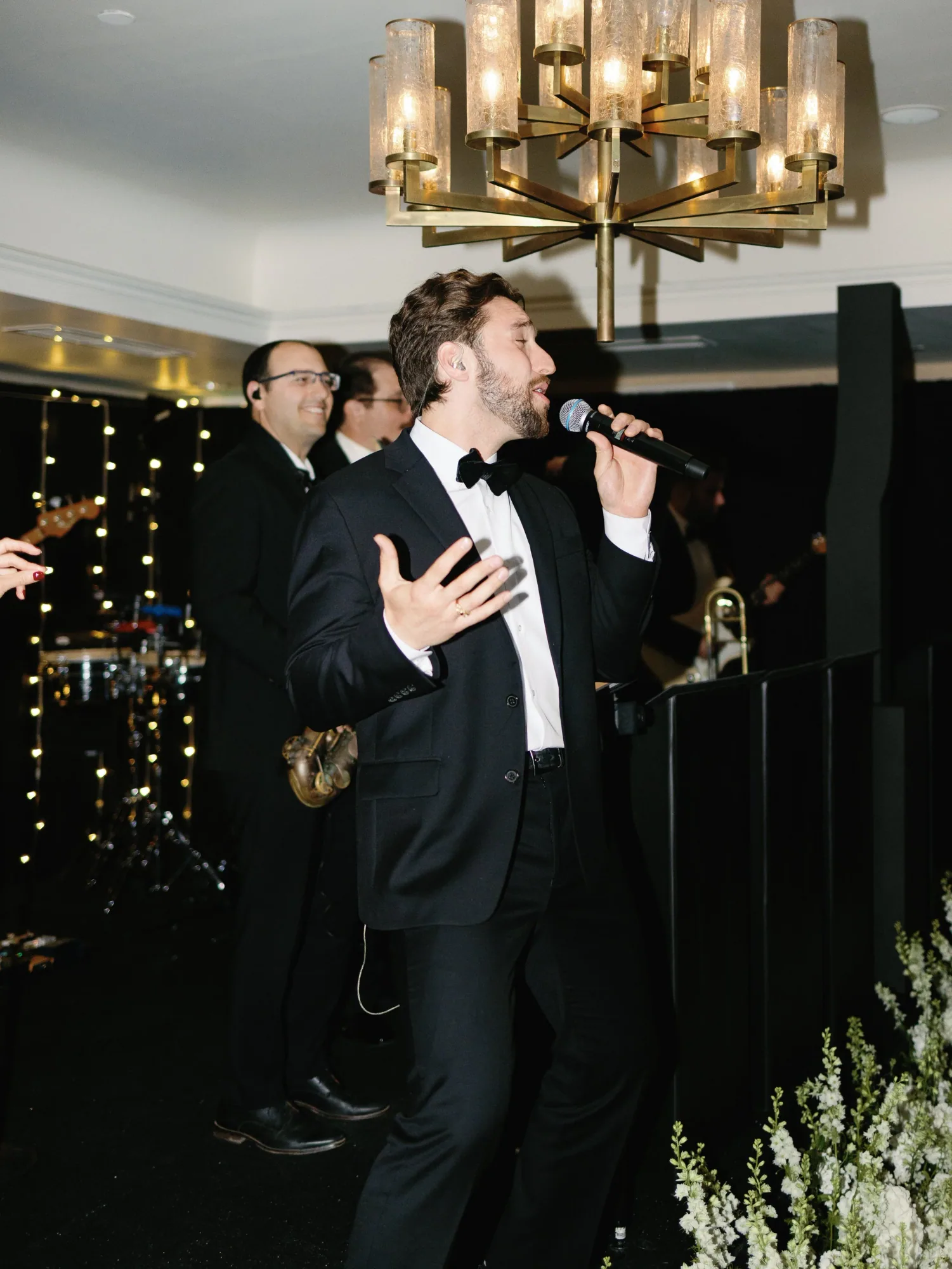 An AMFM vocalist singing during the reception.