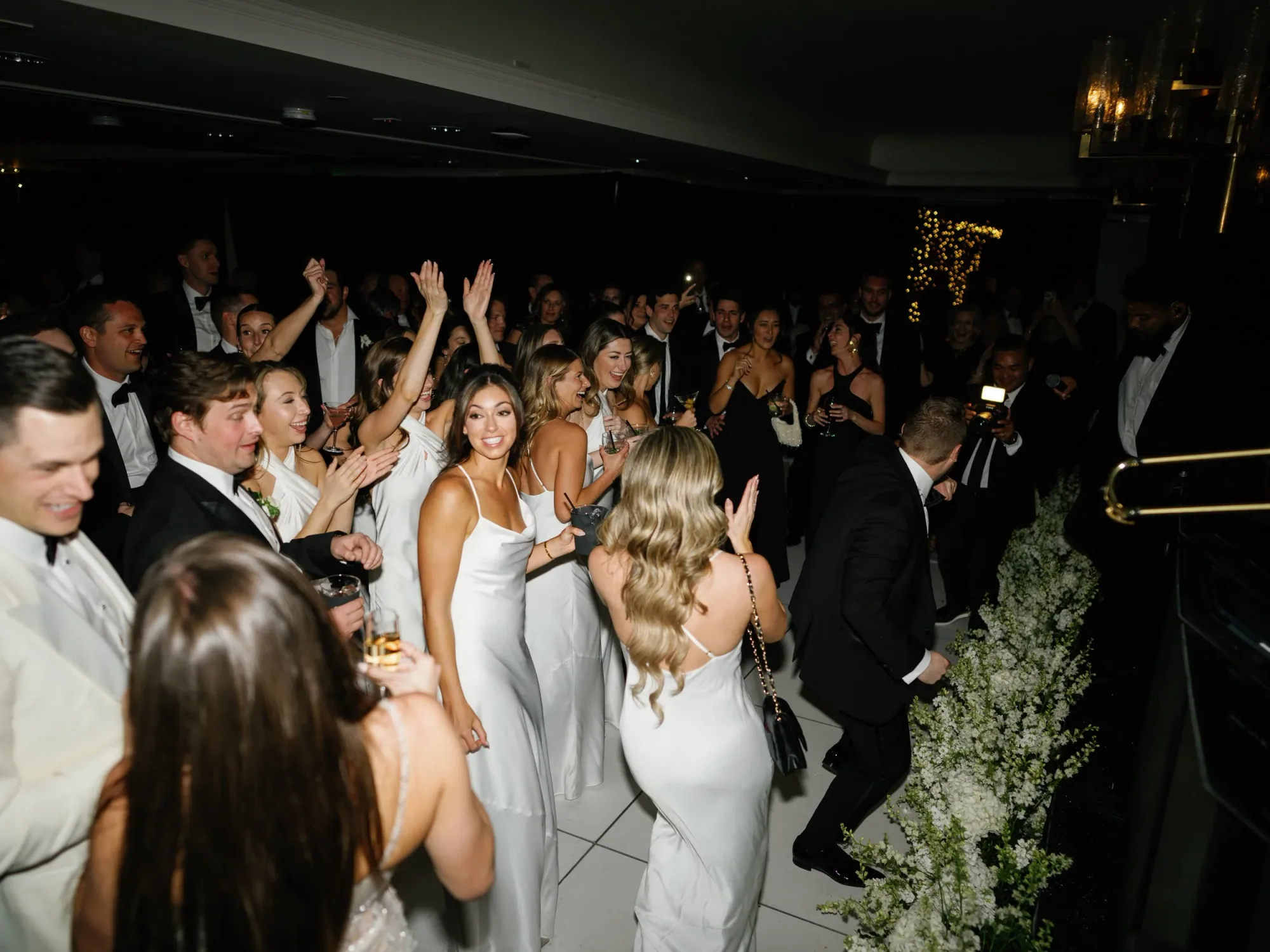 Guests dancing around the performers at the reception.
