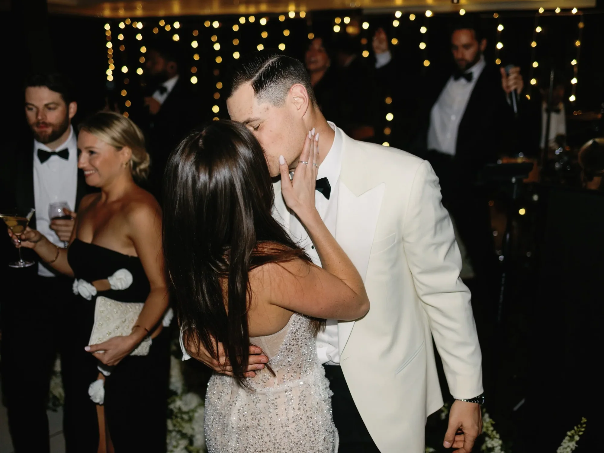 The couple embracing on the dance floor while AMFM performs.