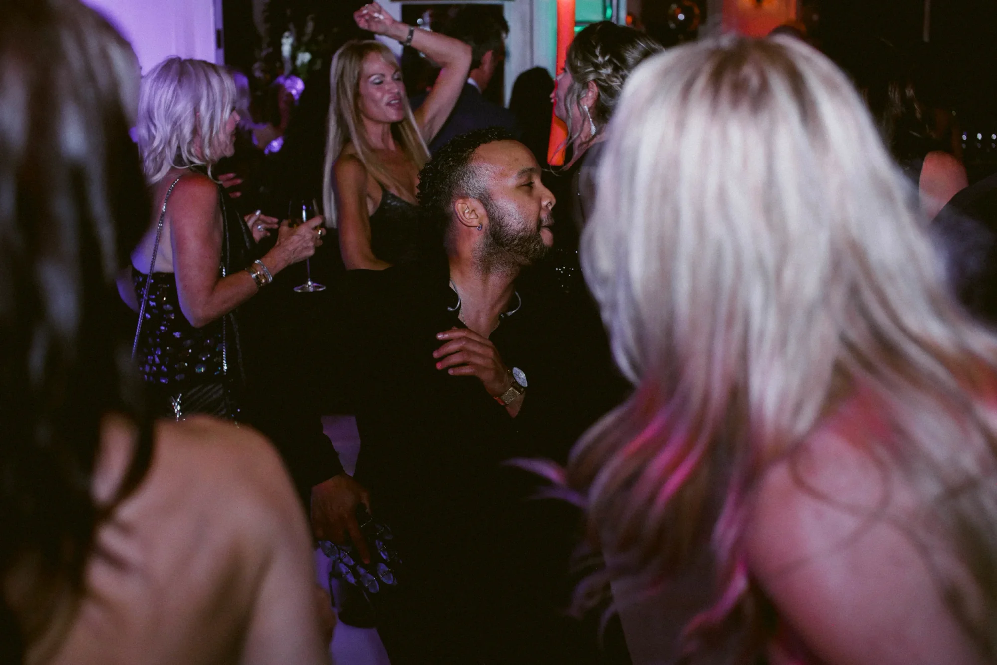Guests dancing around a DJ Live performer.