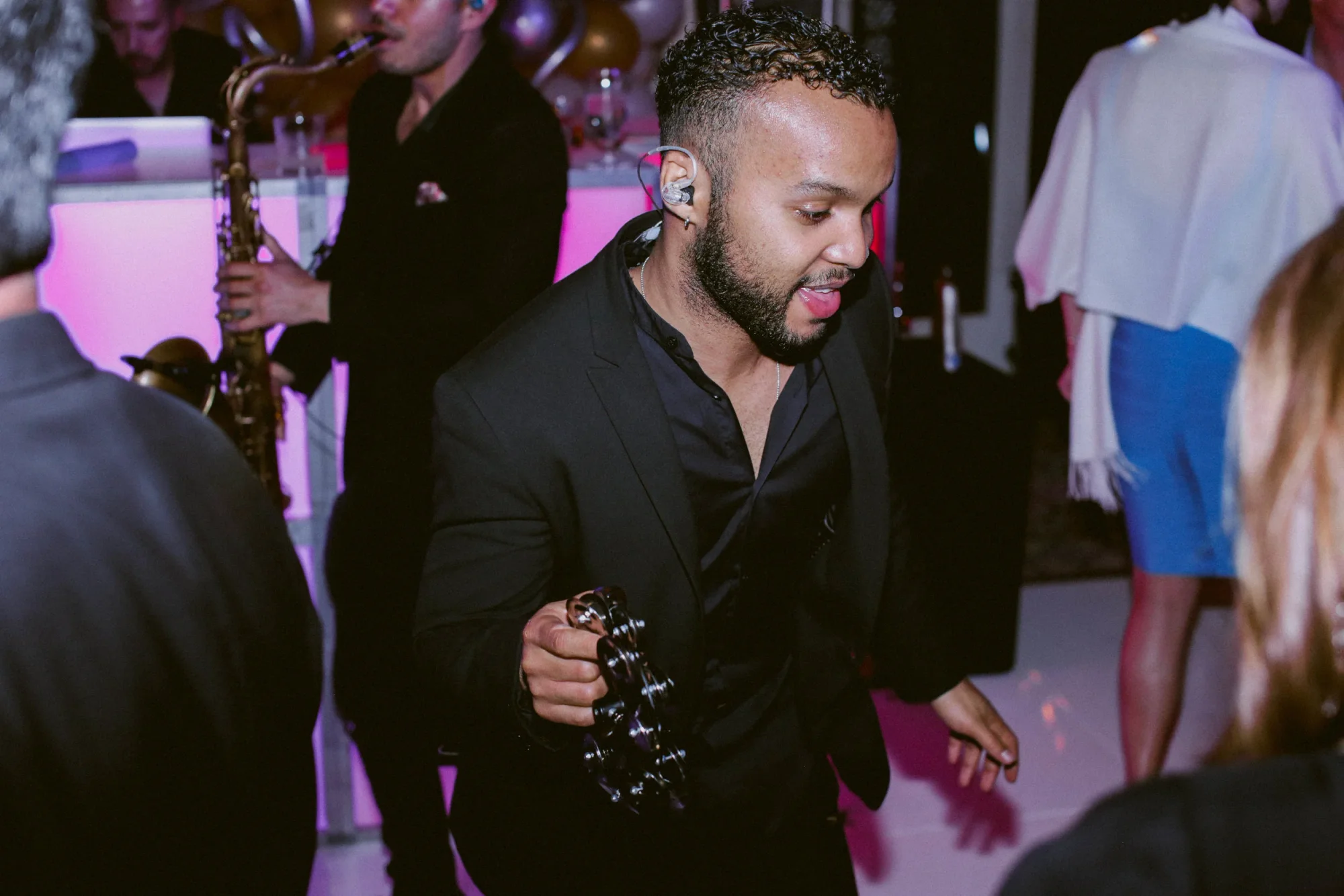 A DJ Live vocalist moving through the dance floor.