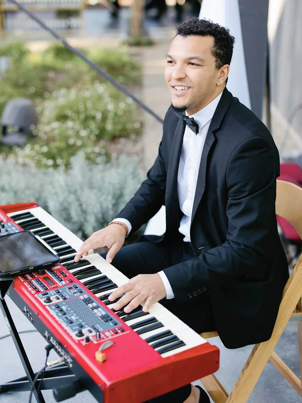 A Gold Standard keyboardist performing outdoors.