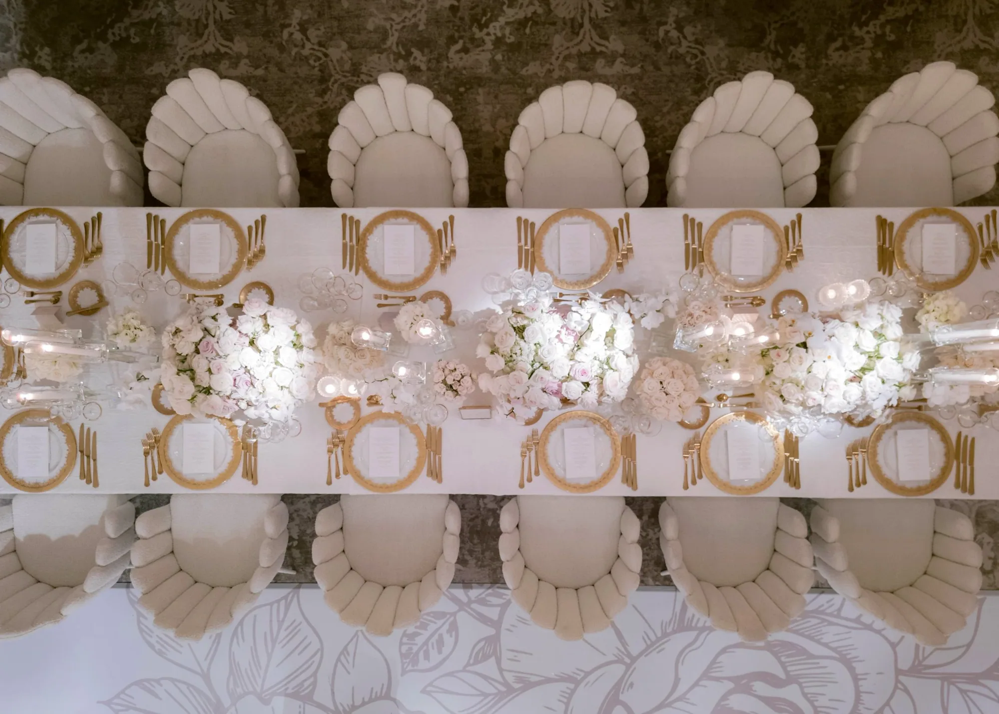 A sculptural white and gold wedding cake.