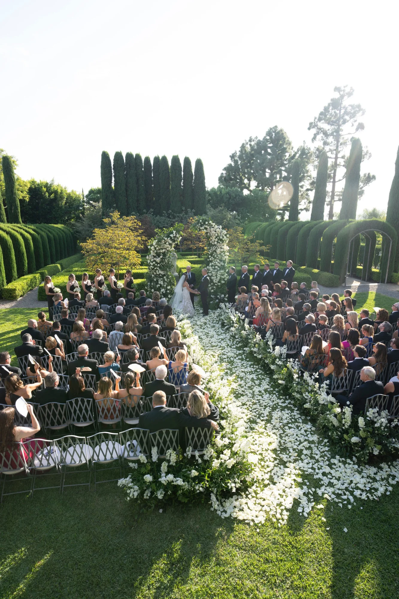A flower-lined garden ceremony at Wilding Estate.