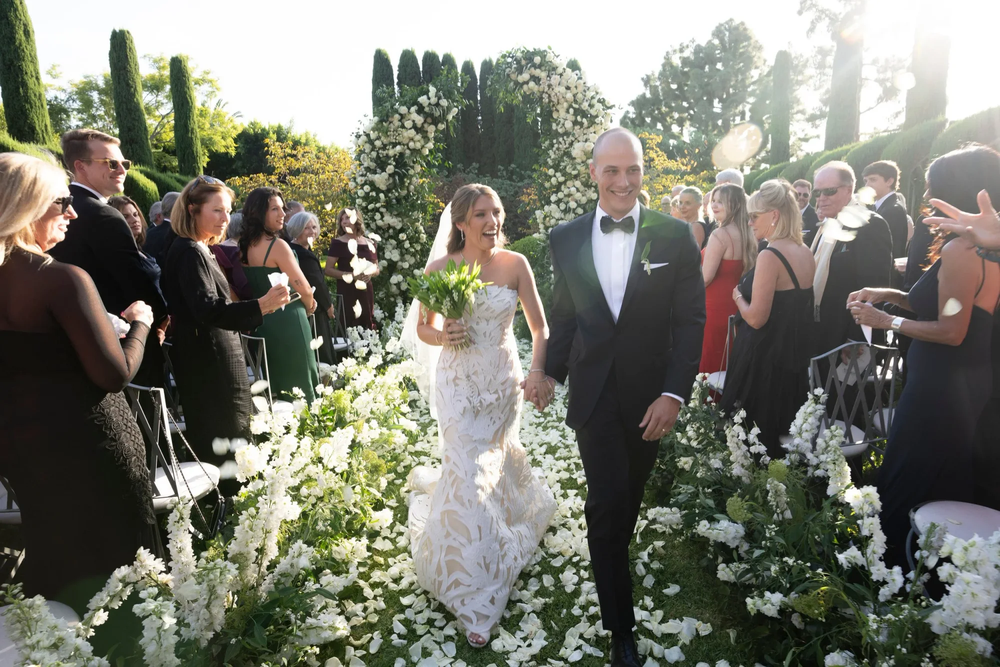 The couple walking through the garden after the ceremony.