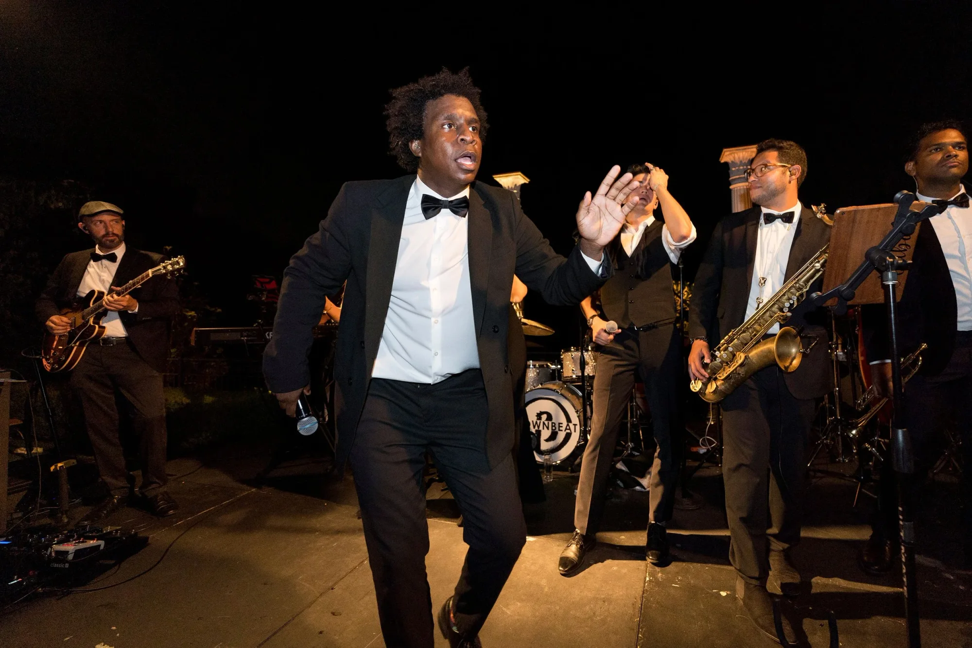 A Soultones vocalist and horn section performing together.
